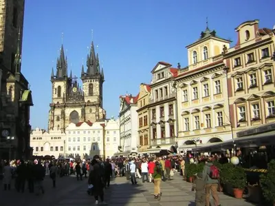 a crowd of people walking down a street with buildings at Rooms in the Center of Old Town in Prague