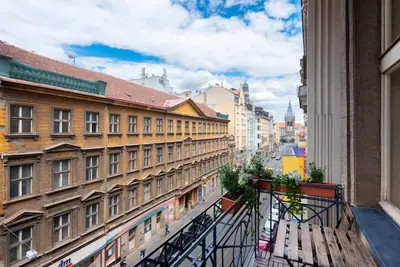 a balcony with a view of a city with buildings at Spacious apartment with balcony at Wenceslas Sq in Prague