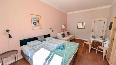 a bedroom with a bed and a living room at Flat in Zizkov -401- in Prague