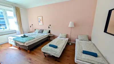 a bedroom with two beds and two benches in it at Flat in Zizkov -401- in Prague