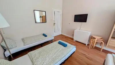 a living room with two beds and a tv at Flat in Zizkov -401- in Prague