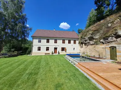 a white house with a yard and a pool at Chalupa Zátyní - celý objekt in Dubá