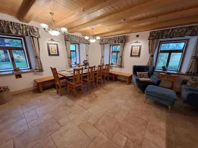 a dining room with a table and chairs at Chalupa Zátyní - celý objekt in Dubá