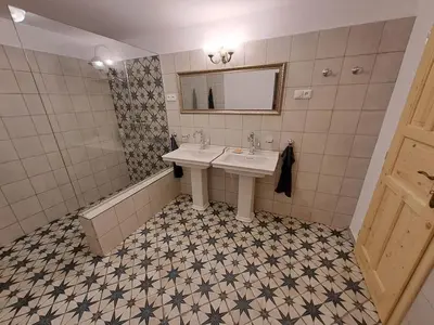 a bathroom with a sink and a mirror at Chalupa Zátyní - celý objekt in Dubá