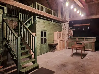 a room with stairs and a desk in a building at Chalupa Zátyní - celý objekt in Dubá