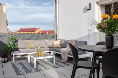 a living room with a chair and a table and a chair at TurnKey I Vineyard Terrace Apartments in Prague