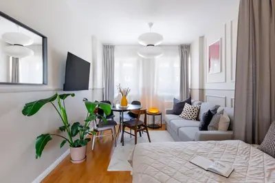 a living room with a gray couch and a table at TurnKey I Vineyard Terrace Apartments in Prague