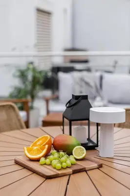 a patio with a couch and a table on a balcony at TurnKey I Vineyard Terrace Apartments in Prague