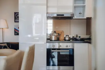 a kitchen with a stove with pots and pans on it at Downtown 2BD riverside apartment near dancing house in Prague