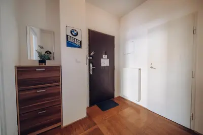 a room with a door and a cabinet and a refrigerator at Downtown 2BD riverside apartment near dancing house in Prague