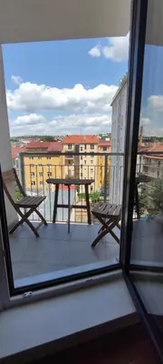 a table and chairs on a balcony with a view at Brand new two room apartment #64 in Elite Rezidence with free secure parking in Prague