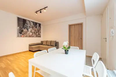 a living room with a white table and chairs at Brand new two room apartment #64 in Elite Rezidence with free secure parking in Prague