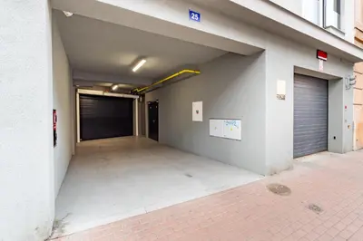an empty parking garage with a garage door at Brand new two room apartment #64 in Elite Rezidence with free secure parking in Prague