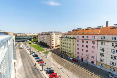 a view of a city street with parked cars and buildings at Brand new two room apartment #64 in Elite Rezidence with free secure parking in Prague