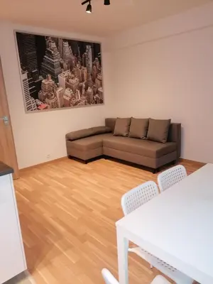a living room with a couch and a table at Brand new two room apartment #64 in Elite Rezidence with free secure parking in Prague