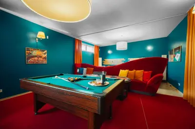 a room with a pool table and a couch at Private Hostel Casino Royal in Prague