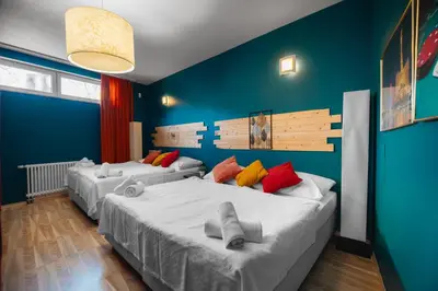two beds in a room with blue walls at Private Hostel Casino Royal in Prague