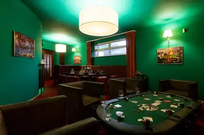 a green room with a table and chairs at Private Hostel Casino Royal in Prague