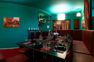 a dining room with a table with glasses on it at Private Hostel Casino Royal in Prague