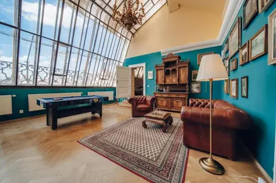 a living room filled with furniture and a pool table at Magnificent historical penthouse in the heart of Prague in Prague