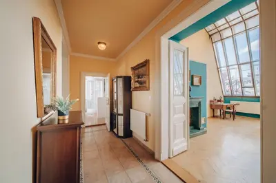 a hallway with a door and a dining room at Magnificent historical penthouse in the heart of Prague in Prague