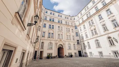 a large building in a city with a street at Magnificent historical penthouse in the heart of Prague in Prague