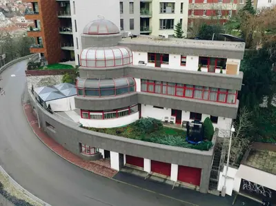 a building with a dome on it next to a street at Vila U Blaženky in Prague