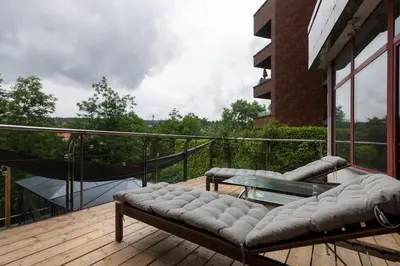 a balcony with a couch and a table on a deck at Vila U Blaženky in Prague