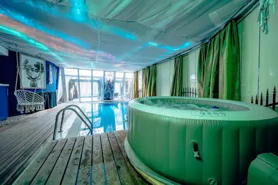 a hot tub in a room with a pool at Vila U Blaženky in Prague