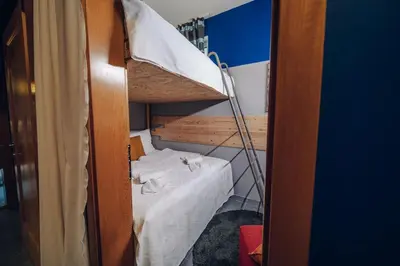 a small room with a bunk bed with a ladder at Vila U Blaženky in Prague