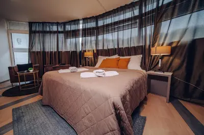 a bedroom with a large bed with towels on it at Vila U Blaženky in Prague