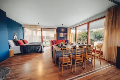 a living room with a dining table and chairs at Marvel 2BD Apartment in modern villa with cozy terrace in Prague