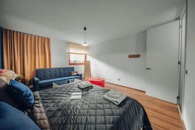 a hotel room with a bed and a couch at Marvel 2BD Apartment in modern villa with cozy terrace in Prague