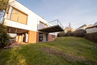 a house with a balcony on top of a yard at Marvel 2BD Apartment in modern villa with cozy terrace in Prague