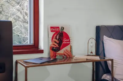 a table with a bottle of beer and a laptop on it at Marvel 2BD Apartment in modern villa with cozy terrace in Prague