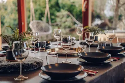 a table with wine glasses and plates on it at Marvel 2BD Apartment in modern villa with cozy terrace in Prague