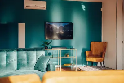 a blue living room with a couch and a chair at Design 3BD apartment cooking area in architect villa in Prague