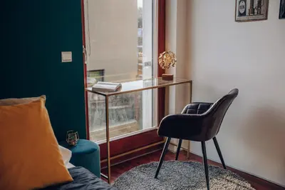 a room with a desk and a chair and a window at Design 3BD apartment cooking area in architect villa in Prague