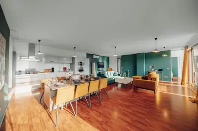 a kitchen and living room with a table and chairs at Design 3BD apartment cooking area in architect villa in Prague