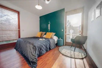a bedroom with a bed and a large window at Design Architect Villa with 2 Apartments in Prague