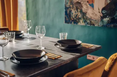 a table with plates and wine glasses on it at Design Architect Villa with 2 Apartments in Prague