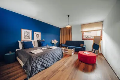 a bedroom with a bed and a blue wall at Design Architect Villa with 2 Apartments in Prague