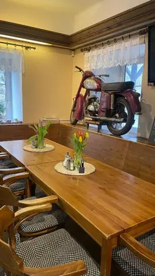 a wooden table with a motorcycle in a room at Penzion Troníček in Kamenný Přívoz