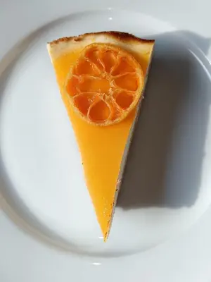 a slice of pizza with an orange on a plate at Penzion Troníček in Kamenný Přívoz