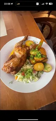 a plate of food with meat and vegetables on a table at Penzion Troníček in Kamenný Přívoz