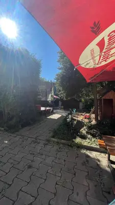 a red umbrella sitting on top of a patio at Penzion Troníček in Kamenný Přívoz