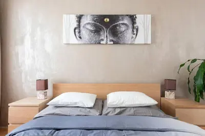 a bedroom with a bed with a picture on the wall at 2 bedrooms apt near Wenceslas sq in Prague