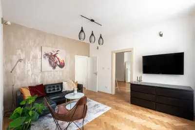 a living room with a couch and a flat screen tv at 2 bedrooms apt near Wenceslas sq in Prague