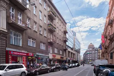 a city street with cars parked on the side of buildings at 2 bedrooms apt near Wenceslas sq in Prague