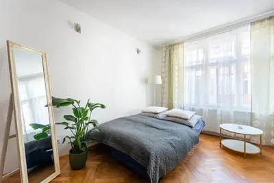 a bedroom with a bed and a mirror at 2 bedrooms apt near Wenceslas sq in Prague
